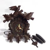 Black Forest cuckoo clock with carved bird surround