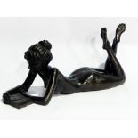 Bronzed model of a nude female lying on her front reading a book, limited edition 135/350,