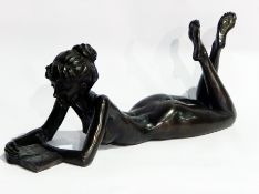 Bronzed model of a nude female lying on her front reading a book, limited edition 135/350,