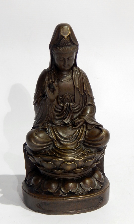 Bronzed metal model of a Hindu goddess sitting on a stylised lotus flower,