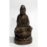 Bronzed metal model of a Hindu goddess sitting on a stylised lotus flower,