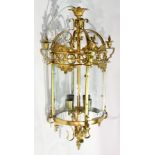 Decorative gilt metal four-light hanging lantern of circular form, having four glass panels,