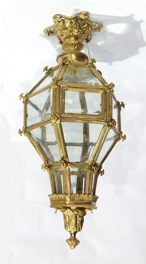 Gilt metal hanging lantern of hexagonal form, having multiple bevelled glass panels,