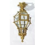 Gilt metal hanging lantern of hexagonal form, having multiple bevelled glass panels,