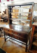 An oak reproduction dresser with open plate rack, with four short drawers,