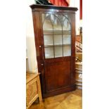 19th century mahogany corner cupboard, the upper lancet glazed section with two shelves,