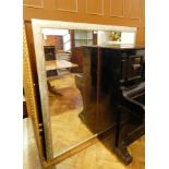 A large rectangular wall mirror in a decorative painted frame,