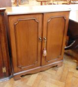 A reproduction mahogany side cabinet with moulded top,