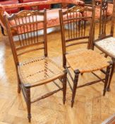 A pair of 19th century chairs with spindle backs and marquetry inlay