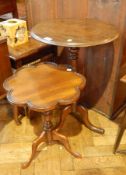 A mahogany circular tilt top side table with turned baluster column and splayed legs together with