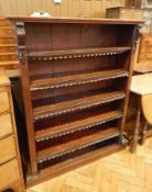 A Victorian mahogany open bookcase with moulded edge top, carved scrollwork mouldings, five shelves,