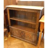 A reproduction oak bookcase with moulded edge top,