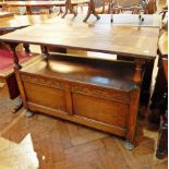 20th century oak monk's bench, with rising top, and compartments below raised on bun feet,