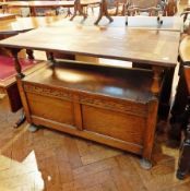 20th century oak monk's bench, with rising top, and compartments below raised on bun feet,