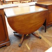 A Georgian style mahogany dropflap dining table with reeded edge,