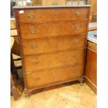 A reproduction walnut veneer chest of five graduated drawers on short cabriole legs,