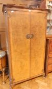 A matching walnut veneer wardrobe with hanging space and fitted shelves,