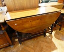 An 18th century fruitwood gateleg table, with oval top,