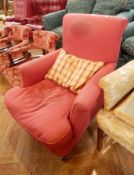 A Victorian red upholstered armchair on square tapering feet with castors