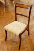 A set of six 19th century dining chairs with upholstered gold and white floral cushions