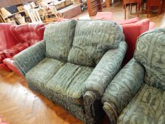 A three piece suite with green upholstery,