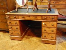 A Victorian mahogany pedestal desk with inset leather writing surface, three frieze drawers,