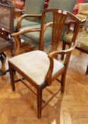 A carvers chair on square shaped bun feet and H-supports