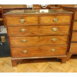 A Georgian mahogany chest of drawers, the reeded edge top with glass plate,