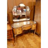 A Queen Anne style walnut veneer triple mirror back kidney shaped  dressing table with central