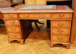 A mahogany reproduction pedestal desk, with inset leather writing surface,