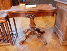 An early Victorian rosewood swivel top card table with baize lined interior,
