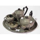 A hammered pewter tea service comprising teapot, hot water jug, cream jug,