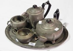 A hammered pewter tea service comprising teapot, hot water jug, cream jug,