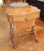 A Victorian walnut folding top games table opening to reveal a chequer board and backgammon and