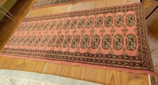 Persian style runner on red ground with black guard, geometric pattern, 1.