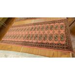 Persian style runner on red ground with black guard, geometric pattern, 1.