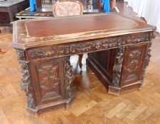 A nineteenth century Renaissance style carved oak partner's desk,