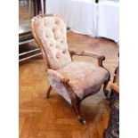 A Victorian carved walnut frame armchair, with foliate carving, button back,