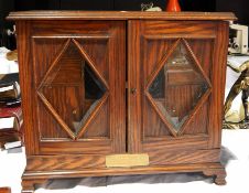 An oak smoker's companion with glazed doors, and presentation plaque,