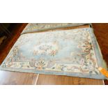 Chinese wool rug on pale blue ground, floral and scroll decoration,