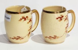 Pair Japanese earthenware mugs, barrel-shaped and painted with maple leaves on cream ground,