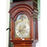 An 18th century walnut longcase clock, with canopied hood, brass dial with silvered chapter ring,