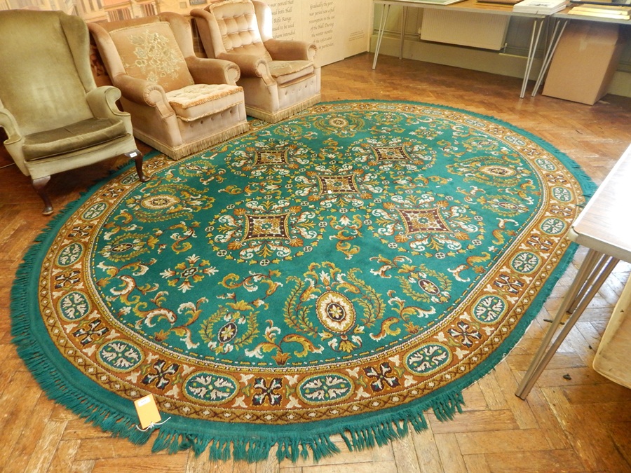 Oval carpet with green field, floral decoration, brown guards, 3.8m x 2.