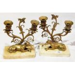 Pair of candelabra on marble plinths with models of a greyhound,