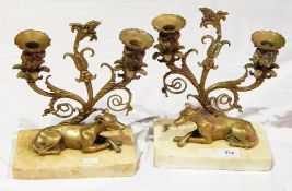 Pair of candelabra on marble plinths with models of a greyhound,