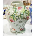 A porcelain vase with painted decoration of peaches on a peach tree, with a bat,