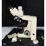 Microscope made by Zeiss standard 25 with various attachments and a plastic cover