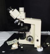Microscope made by Zeiss standard 25 with various attachments and a plastic cover