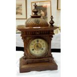 An eight-day movement clock with finials,