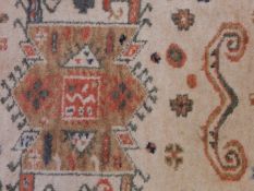 A Persian-style wool runner on white ground with geometric pattern and a smaller similar patterned